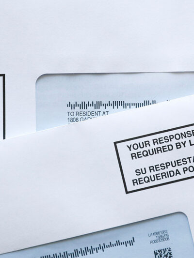 Two envelopes containing 2020 U.S. Census forms.