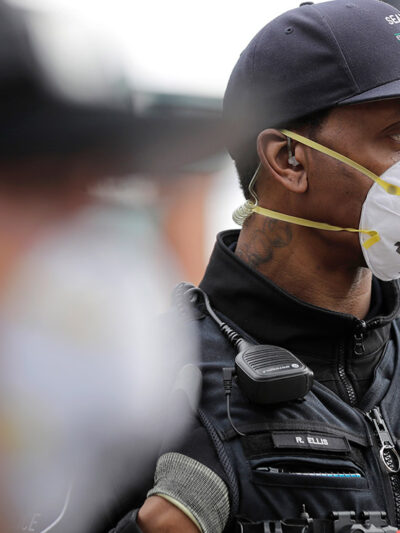 Two Seattle police officers wearing N95 masks.