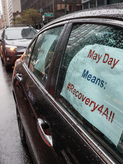 A caravan of May Day protestors drive up 2nd Avenue in New York City during COVID pandemic.