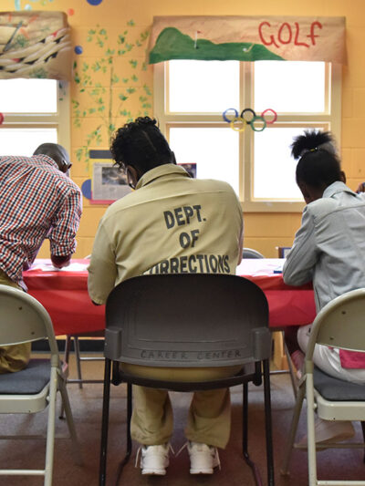 A woman held at the Pulanski State Prison in Georgia plays with her children in the prison's Children Center.