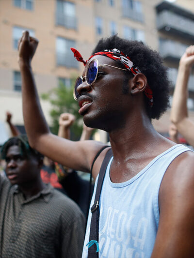 Demonstrators with fists raised in solidarity.