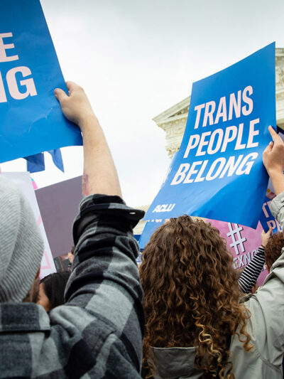 Demonstrators outside the Supreme Court with signs advocating for the rights of LGBTQ people.