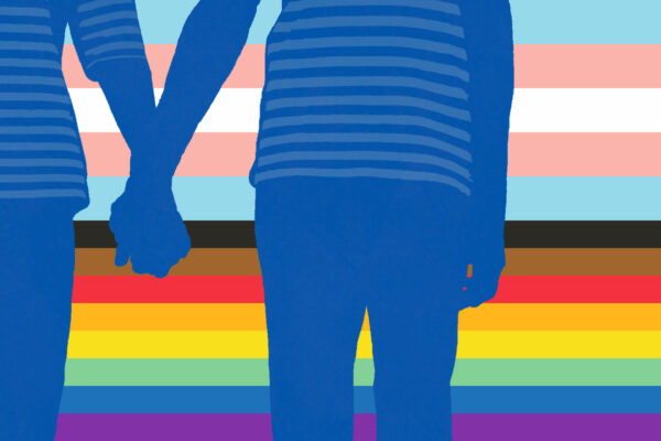 Two people holding hands with LGBTQ+ flag behind them