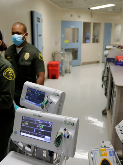 Custody assistants walking through hallway of the hospital ward in a jail in Los Angeles.