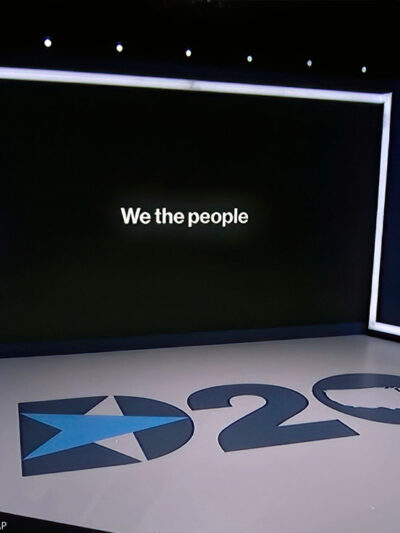 The set in Los Angeles during the first night of the Democratic National Convention. "We the People" can be read on the monitor.