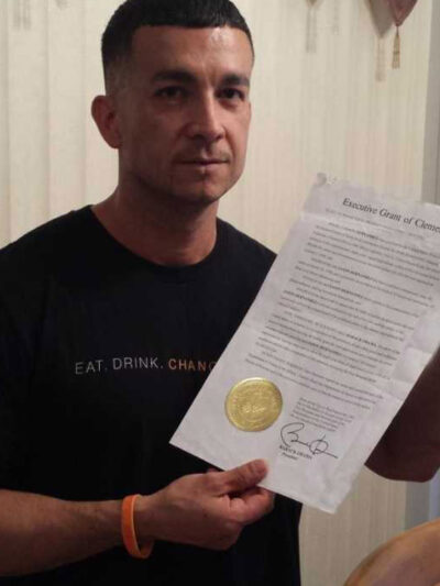Jason Hernandez holding his executive grant of clemency given by President Barack Obama.