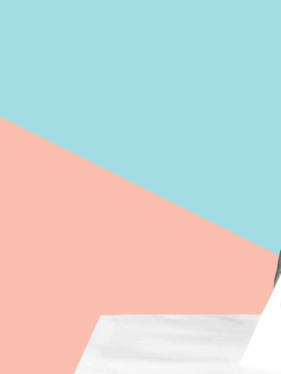 A hand putting a ballot into a ballot box.