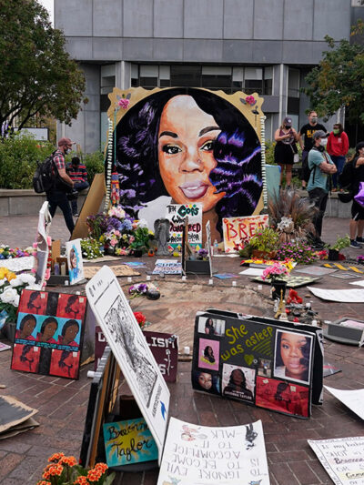 People gather in Jefferson Square in Louisville, awaiting word on charges against police officers in the death of Breonna Taylor.