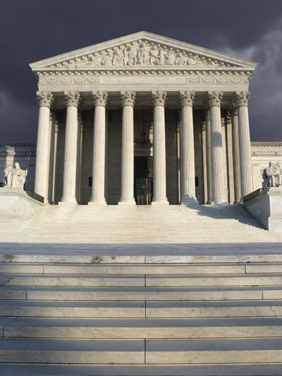 The Supreme Court beneath a cloudy sky.