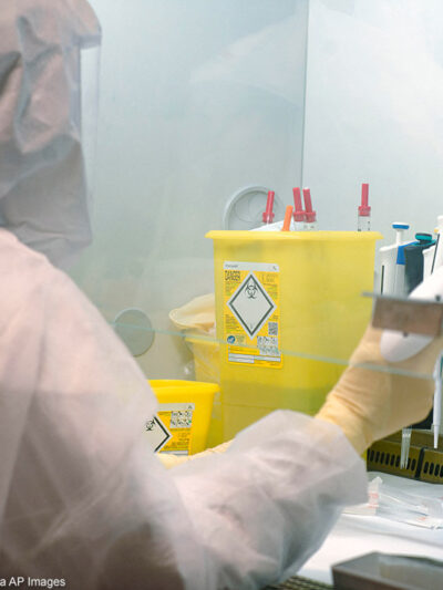 Scientists at work in high-level P3 biosafety security laboratory.