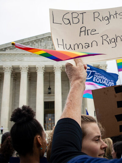 Demonstrators outside the Supreme Court with signs advocating for the rights of LGBT people.