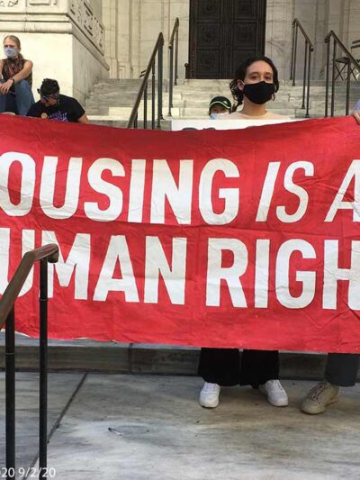 Protestors hold aloft a saying HOUSING IS A HUMAN RIGHT at a protest in New York City, September 2, 2020