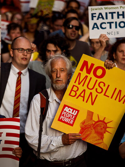 People protest during a rally about the U.S. Supreme Court's decision to uphold President Donald Trump’s ban on travel from several mostly Muslim countries.