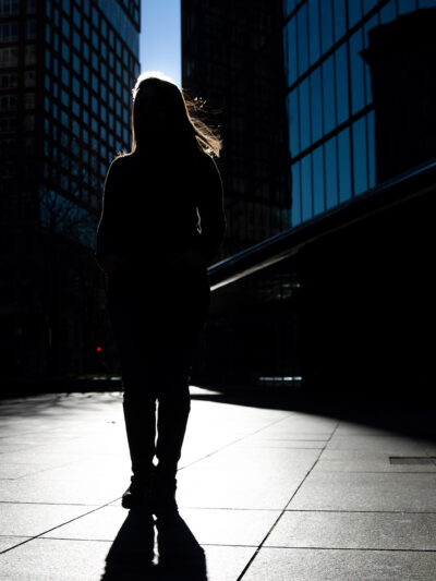 Silhouette of Farah, one of the woman in this blog, standing in front of skyscrapers