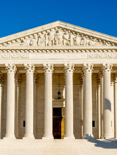 Photo of the front of the Supreme Court building on a sunny day