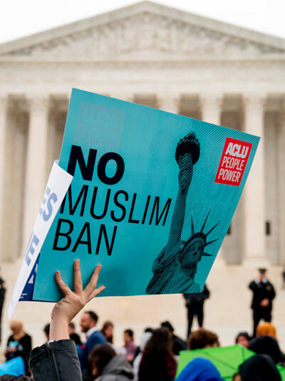 A person holds up a sign that reads "No Muslim Ban" during an anti-Muslim ban rally at the Supreme Court.