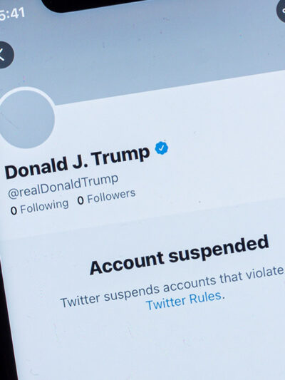 A smartphone showing Donald J. Trump's suspended Twitter account.
