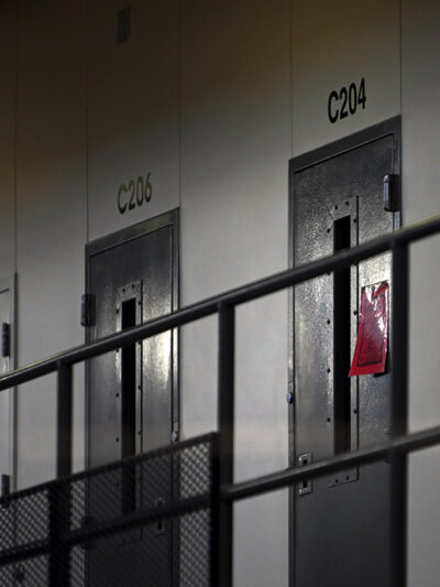 A red tag hangs on a cell door, signifying an active COVID-19 case for its inhabitants in the Minnesota prison.