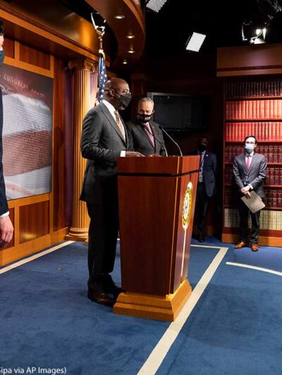 U.S. Senator Raphael Warnock (D-GA) speaking, with U.S. Senator Jon Ossoff (D-GA) and Senate Majority Leader Chuck Schumer (D-NY) standing next to him, about the COVID-19 relief legislation being worked on in the Senate, on February 11. 2021.