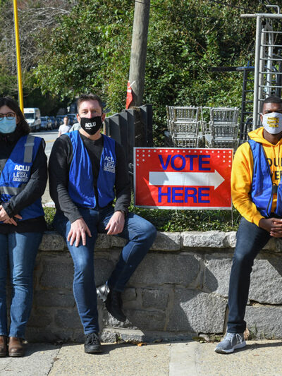 ACLU legal observers sit by a "Vote Here" sign outside a polling place in Georgia on Election Day.