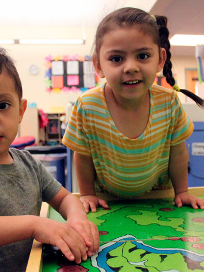 A young boy and girl play with their toy cars to wrap up the day at a day care Albuquerque, New Mexico