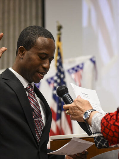 Mike Elliott takes the oath of office as the city's new mayor with city clerk Barb Suciu, right, during Elliot's inauguration ceremony