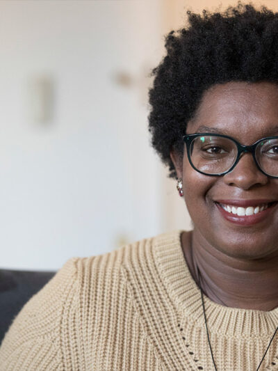 Ashley C. Ford wears beige sweater.