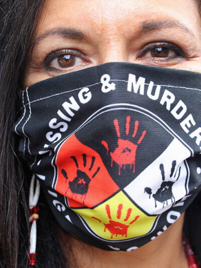 Jeannie Hovland, the deputy assistant secretary for Native American Affairs for the U.S. Department of Health and Human Services, poses with a Missing and Murdered Indigenous Women mask.