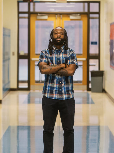 Anthony, a teacher profiled in this blog, stands in the middle of his school's hallway