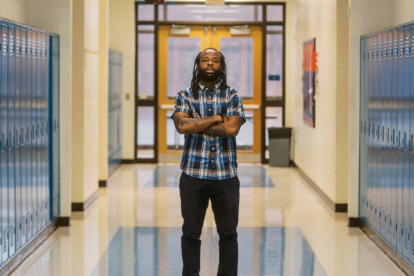 Anthony, a teacher profiled in this blog, stands in the middle of his school's hallway