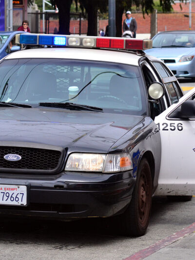Modern SFPD police car cruiser with the door on the driver side open.