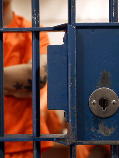 Photo of an inmate behind bars.