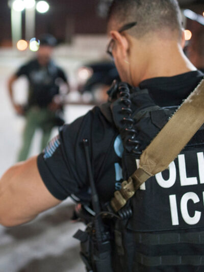 The back of a police vest reads "Police ICE"