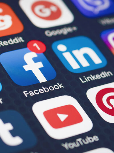 Social media icons on a smartphone screen.