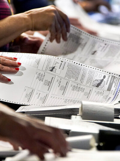 Election workers handle ballots at the Allegheny County Election Division warehouse in Pittsburgh.