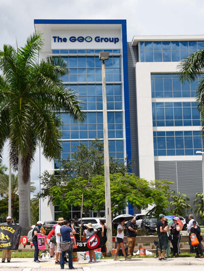 Protestors march in front of the ICE Company, The Geo Group building, demanding the end of private prisons.