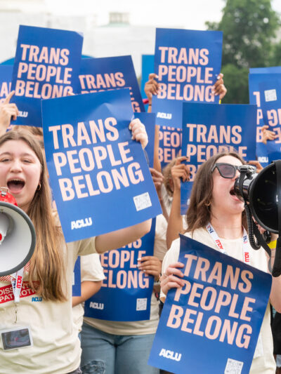 A group of young demonstrators holding ACLU signs that say Trans People Belong.