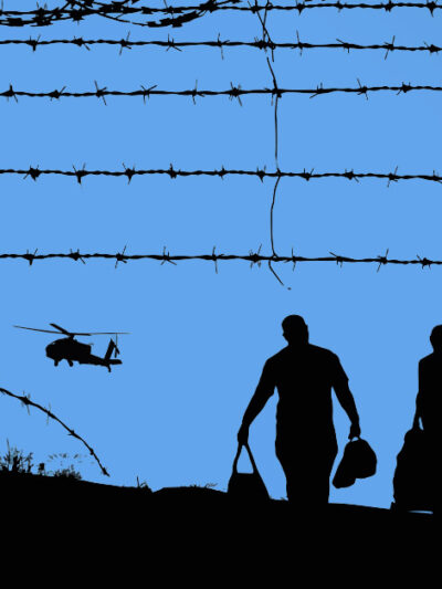 Fence with spikes and helicopter at immigration detention center.