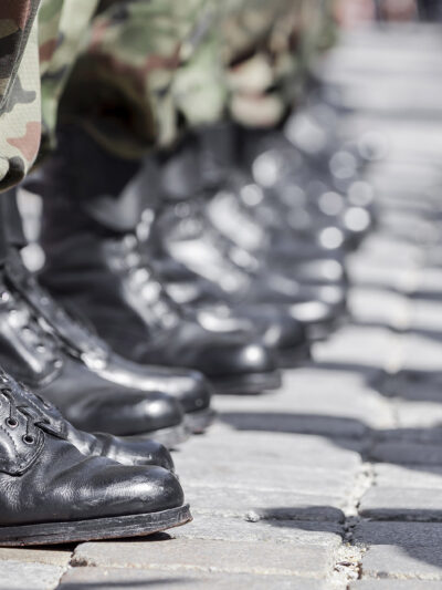 A row of boots belonging to military soldiers.