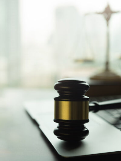 A gavel on a laptop.