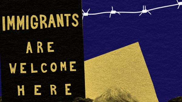 Protests signs reading Immigrants Are Welcome Here with barbed wire in the background
