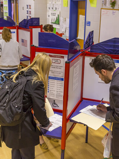 Voters fill out paper ballots on election day.