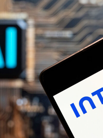 Software company Intuit logo seen displayed on a smartphone with an Artificial intelligence (AI) chip and symbol in the background.