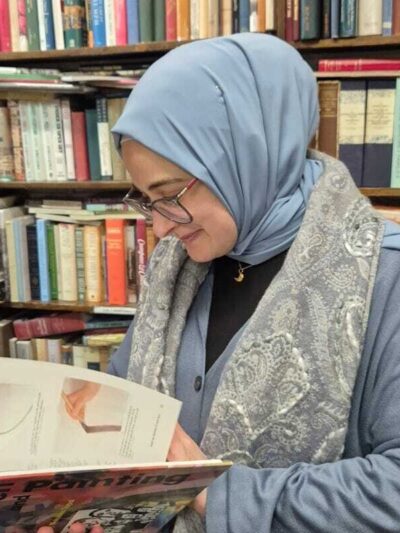 Rümeysa Öztürk reads an art book.