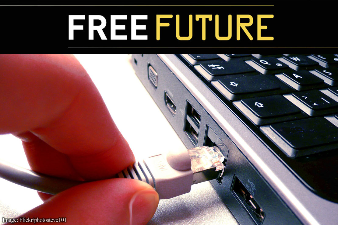 Two fingers disconnecting a network cable from a computer