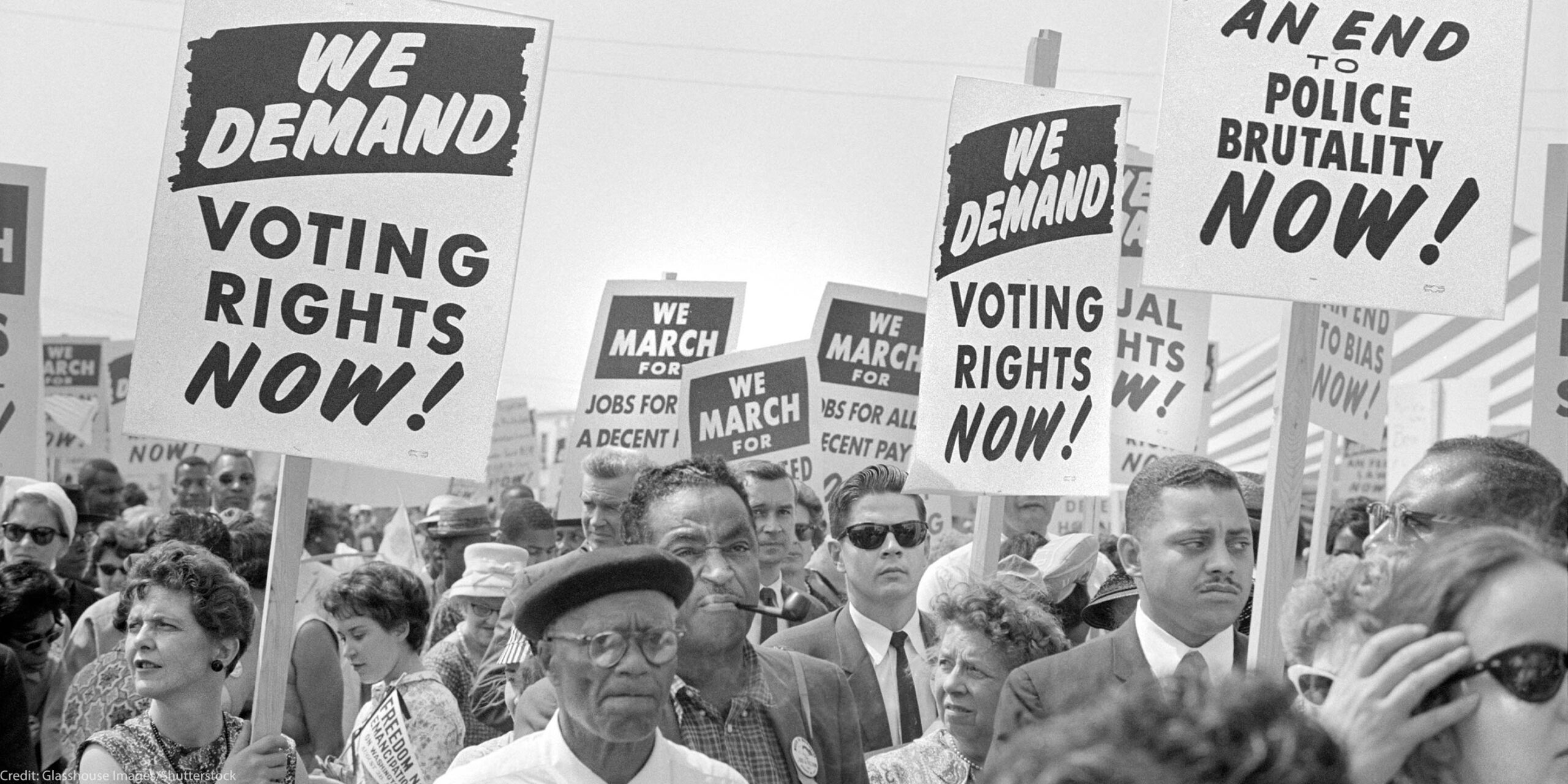 Protesters with signs at march on Washington, D.C. for Jobs and Freedom, carrying signs that read "WE DEMAND VOTING RIGHTS NOW!" and WE DEMAND AN END O POLICE BRUTALITY NOW!" on August 28, 1963.