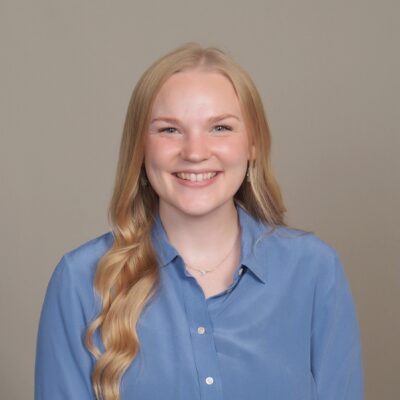 White woman with blond hair and blue shirt