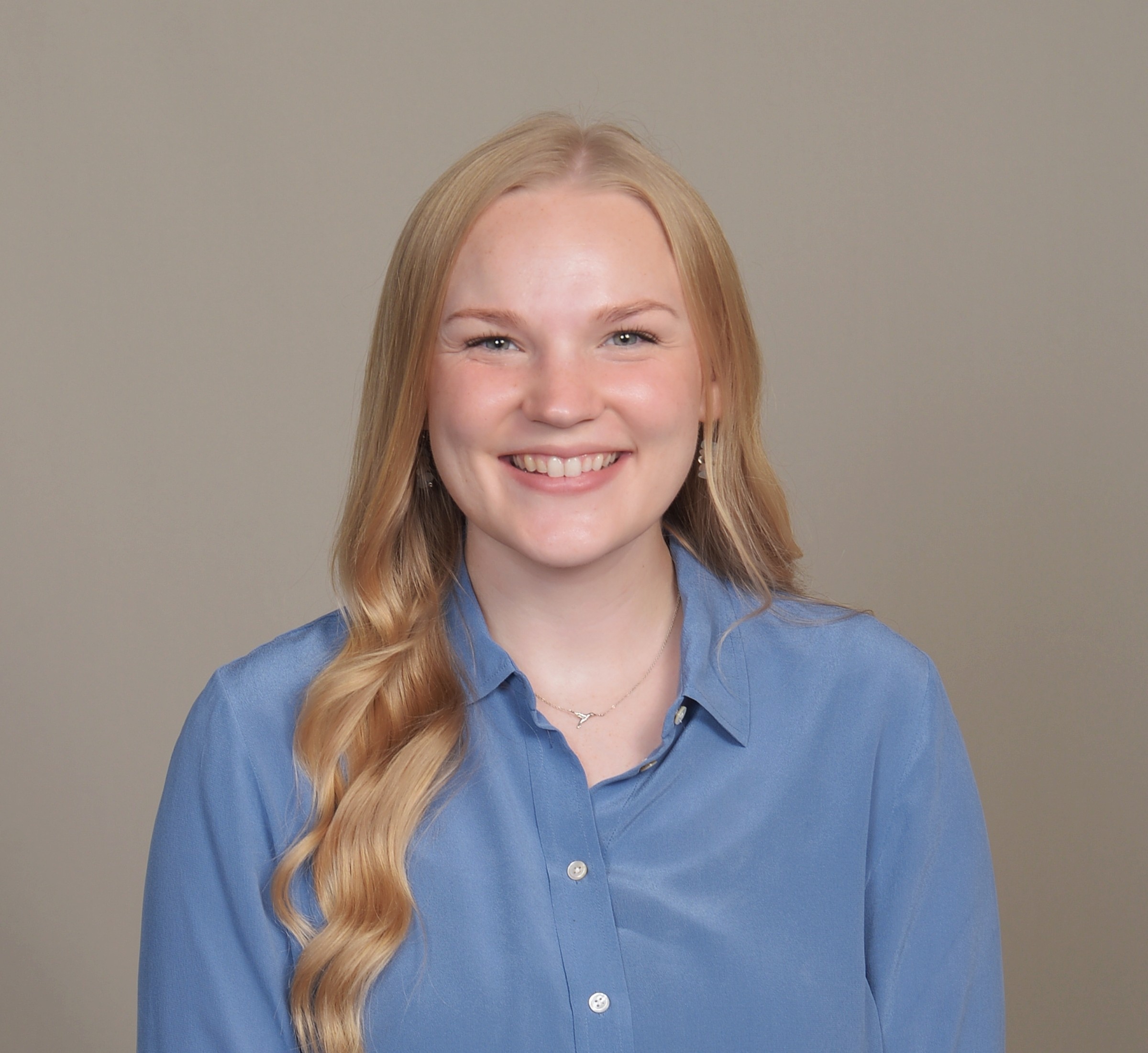 White woman with blond hair and blue shirt