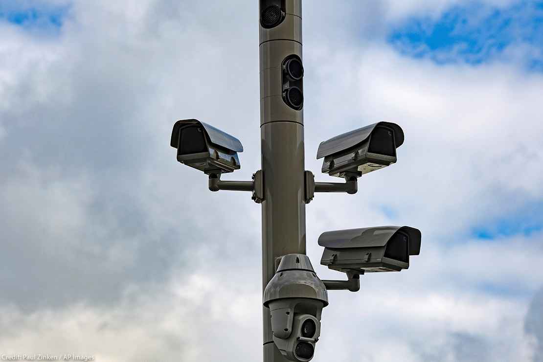 Surveillance cameras on a street pole.