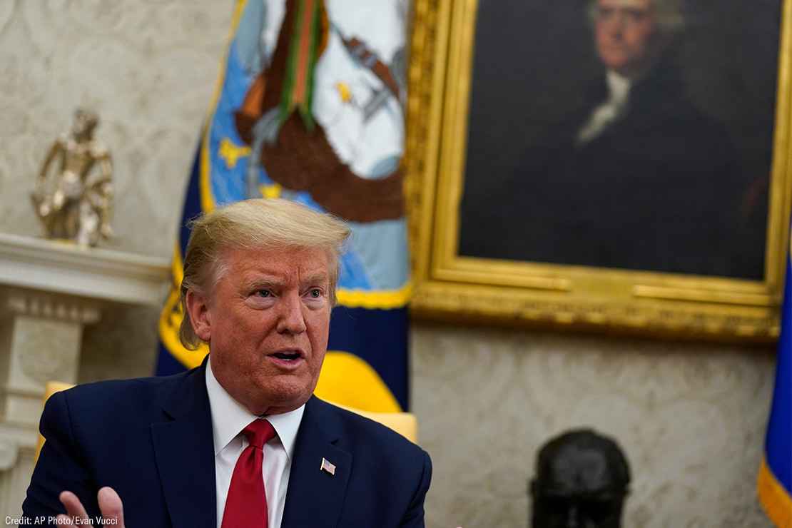 Donald Trump speaking in the Oval Office with a painting of George Washington in the background.